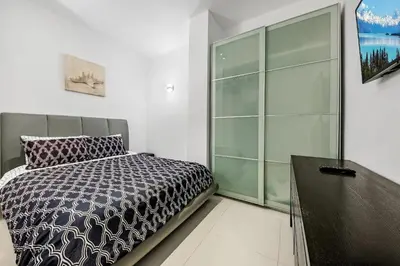 a bedroom with a bed and a glass wall at Oceanfront Luxury Penthouse On The Beach 3 Bedroom in Hollywood