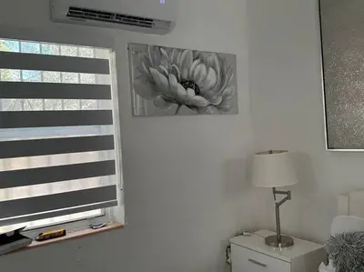 a room with a window with a flower picture on the wall at Villa Clara SUITE - Little Havana in Miami