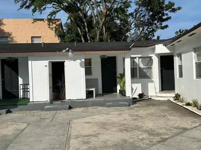 a white house with a lot of windows at Villa Clara SUITE - Little Havana in Miami