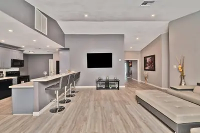 a kitchen and living room with a bar and a couch at Spacious 4 bedrooms, 2 bathroom house with pool in Miramar