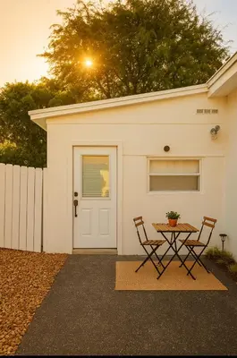 a table and two chairs in front of a garage at Modern Home - Termpurpedic Queen bed, Laundry, Free Parkging, EV Tesla in Hollywood