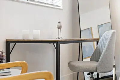 a bird sitting on a desk with two chairs at Lovely Studio with Great Location + Free Parking in Fort Lauderdale