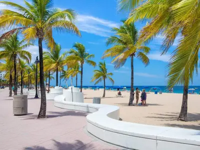 a beach with palm trees and the ocean at Villa Oasis 3 Miles to Hard Rock Stadium & Casino, Guitar Hotel Nearby, Pool, Game Room, Sleeps 12, 15 Min to Beach in Pembroke Pines