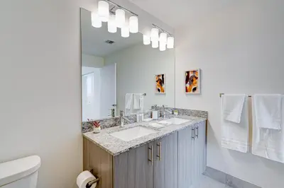 a bathroom with a sink and a mirror at 805MM DOWNTOWN DORAL CONDO 2 BEDROOMS & 2 BATHROOMS in Miami