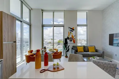 a kitchen and living room with large windows at 3900-502GJ DESIGN DISTRICT, CONDO 2 BEDROOMS & 2 BATHROOMS in Miami