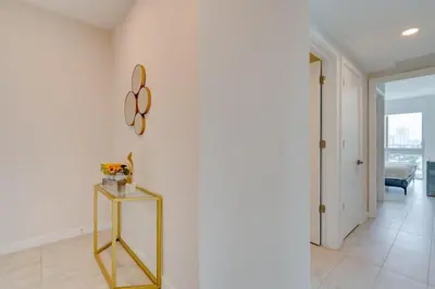 a room with a mirror on the wall and a table at 3900-902CH DESIGN DISTRICT, CONDO 2 BEDROOMS & 2 BATHROOMS in Miami