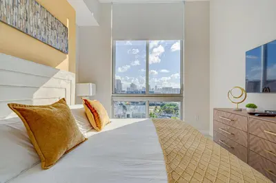 a bedroom with a large bed with two pillows at 3900-602LG DESIGN DISTRICT, CONDO 2 BEDROOMS & 2 BATHROOMS in Miami