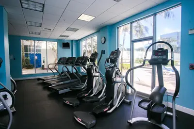 a gym with a row of cardio machines in a room at Sian Oceanfront Condos in Hollywood