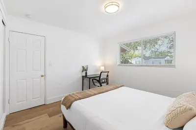 a white bedroom with a bed and a window at The Perfect Escape @Lake Ridge in Fort Lauderdale
