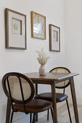 a dining room table with two chairs and a vase on it at Charming cozy studio @ Lake Ridge in Fort Lauderdale