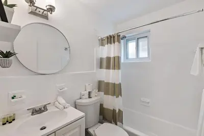 a bathroom with a sink and a toilet and a mirror at Charming cozy studio @ Lake Ridge in Fort Lauderdale