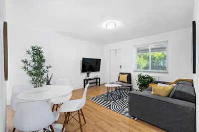 a living room with a couch and a table at Lake Ridge Villa - Free Parking in Fort Lauderdale