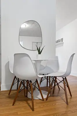a white dining room with a mirror and white chairs at Lake Ridge Villa - Free Parking in Fort Lauderdale