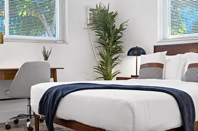 a bedroom with a bed and a desk and a chair at Lake Ridge Villa - Free Parking in Fort Lauderdale