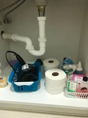 a bathroom counter with toilet paper and a sink at Modern apartment steps the beach in Miami Beach
