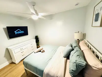 a bedroom with a bed and a tv on the wall at Progresso Apartments & Homes by Lowkl in Fort Lauderdale