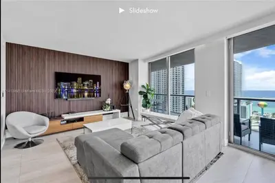 a living room with a couch and a tv at Apartment 3B/3B Bay View in Hallandale Beach
