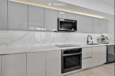 a white kitchen with a sink and a stove at Apartment 3B/3B Bay View in Hallandale Beach