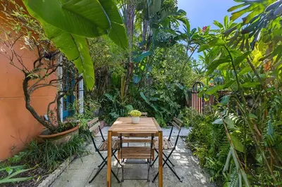 a wooden table and chairs in a garden at Welcoming Airbnb Walkig distance to Las Olas Blvd in Fort Lauderdale