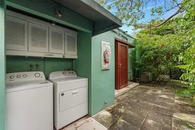 a green house with a washer and dryer at Beautiful Apt in Victoria Park (Las Olas Blvd) in Fort Lauderdale