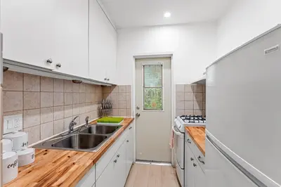 a kitchen with white cabinets and a sink at Beautiful Apt in Victoria Park (Las Olas Blvd) in Fort Lauderdale