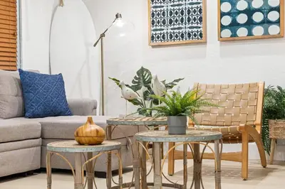 a living room with two tables and a couch at Bright and Stylish Apt in Las Olas Blvd Victoria Park in Fort Lauderdale