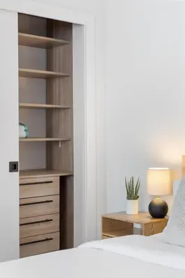 a bedroom with a bed and a desk with a lamp at Mango House en Dania Beach in Dania Beach
