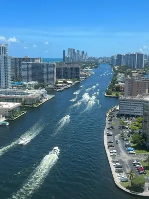 a river with a boat in a city with buildings at Apartment 3B/3B Bay View in Hallandale Beach