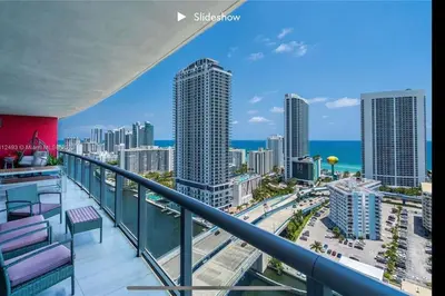 a balcony with a view of the ocean and buildings at Apartment 3B/3B Bay View in Hallandale Beach