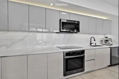 a white kitchen with a sink and a stove at Apartment 3B/3B Bay View in Hallandale Beach