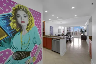 a painting of a woman on a wall in a room at Ray of Light! Miami Penthouse! in Miami