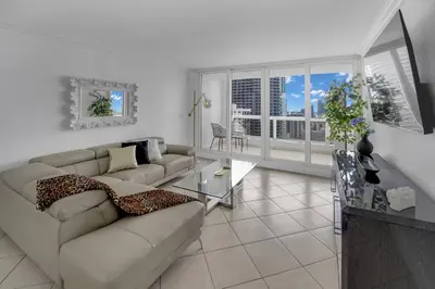 a living room with a couch and a table at Ray of Light! Miami Penthouse! in Miami