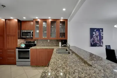 a kitchen with a sink and a counter top at Ray of Light! Miami Penthouse! in Miami