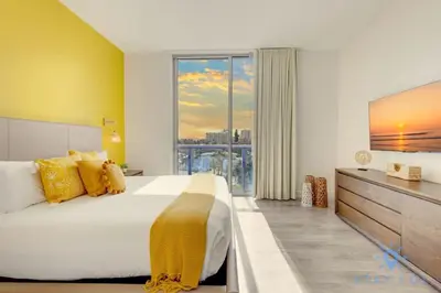 a bedroom with a large bed and a large window at Lovely Apt for 6 - Hollywood Beach Broad - walk in Hollywood