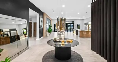 a lobby with a table in a building at Waterfront Mansion The GlamHomes in North Miami Beach