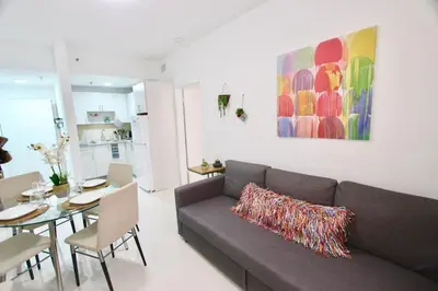 a living room with a couch and a table at BEAUTIFUL APARTMENT FOOTSTEPS FROM THE BEACH in Miami Beach