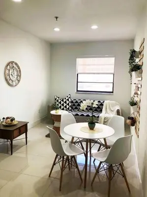 a dining room with a table and white chairs at MODERN AND ECLECTIC APARMENT A STEPS THE BEACH in Miami Beach