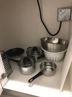 a group of pots and pans on a counter in a kitchen at MODERN AND ECLECTIC APARMENT A STEPS THE BEACH in Miami Beach