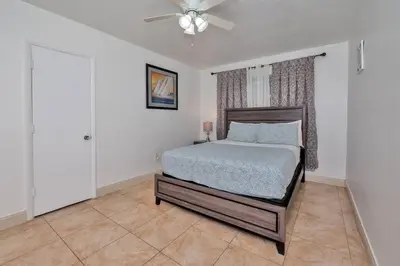 a bedroom with a bed and a ceiling fan at Luxurious 5 bedrooms Jacuzzipool in Miramar
