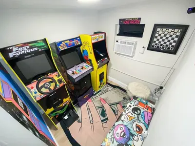 a room with a video game console and a game machine at Unique Miami Art Escape w/ HotTub, Arcade & Murals in Miami