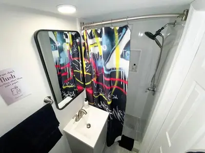 a bathroom with a sink and a mirror at Unique Miami Art Escape w/ HotTub, Arcade & Murals in Miami