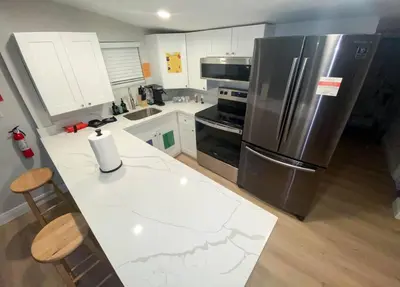 a kitchen with a large stainless steel refrigerator at Unique Miami Art Escape w/ HotTub, Arcade & Murals in Miami