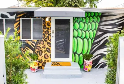 a house with a painted exterior with a door at Unique Miami Art Escape w/ HotTub, Arcade & Murals in Miami