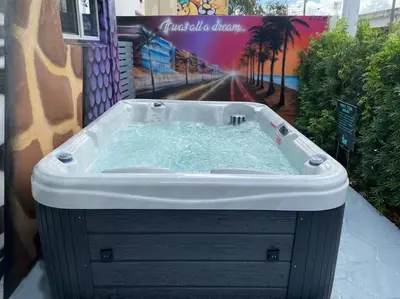 a bath tub with water in it next to a building at Cozy & Colorful Miami Art Canvas w/HotTub & Murals in Miami