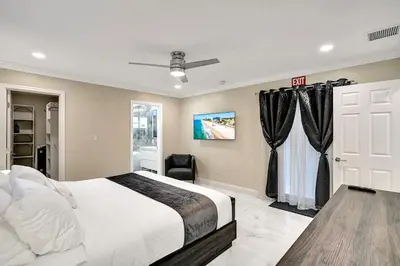 a bedroom with a white bed and a window at Sensational 5BR Villa Heated Pool near Hard Rock in Hollywood