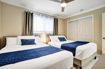 two beds in a room with blue and white at Sensational 5BR Villa Heated Pool near Hard Rock in Hollywood