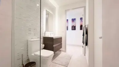 a white bathroom with a toilet and a sink at New 1/1 Apartment in Smart Brickell with Parking in Miami