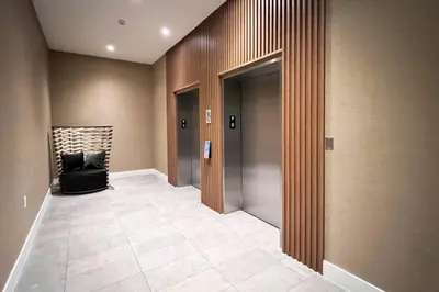 a lobby with a hallway with a chair and elevator at New 1/1 Apartment in Smart Brickell with Parking in Miami