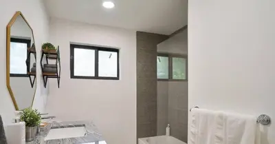 a white bathroom with a sink and a mirror at Luxurious Villa with Elegant Interior and Mini Golf TGH in Hollywood