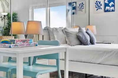 a bedroom with a bed and a table and chairs at Vista Mar: Bay Views Close to Miami Attractions in Miami Beach